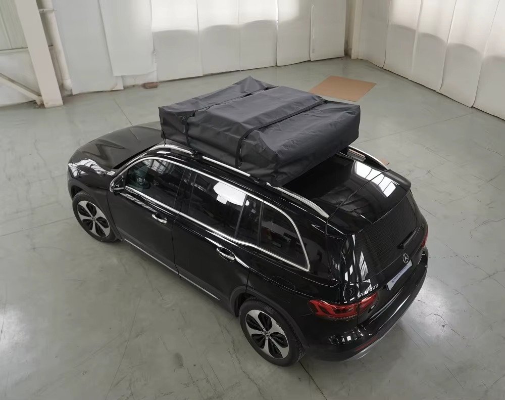 Foldable car rooftop tent secured on SUV roof for travel