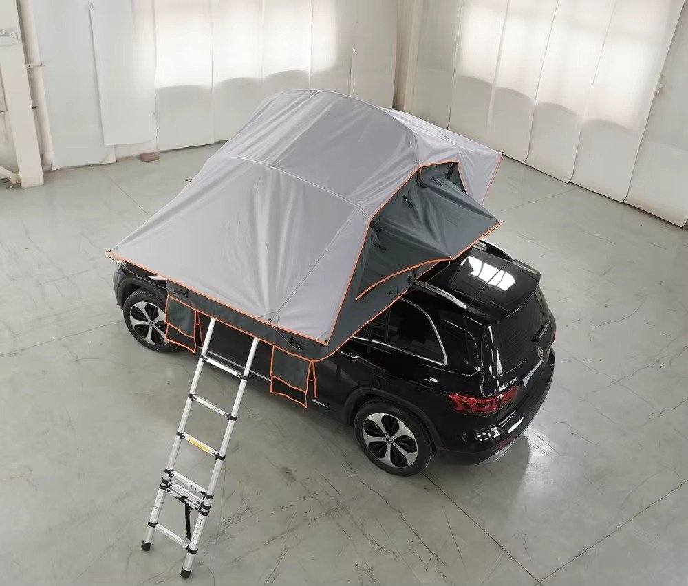 Foldable rooftop camping tent with extended rainfly on SUV