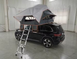 Foldable soft shell rooftop tent mounted on SUV for camping