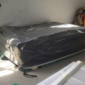 Folded rooftop tent showing its outer cover and base structure.