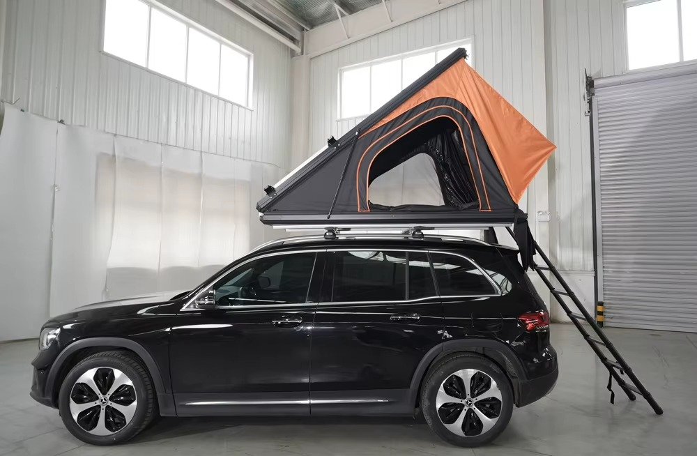 Side view of hard shell rooftop tent mounted on SUV