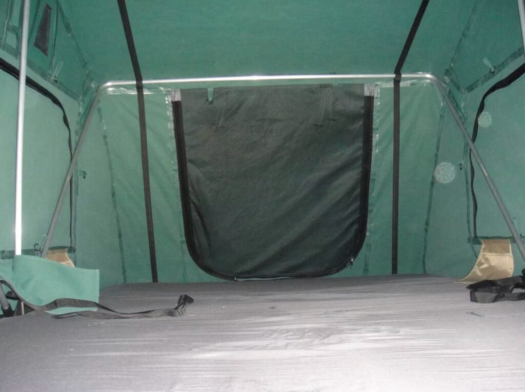 Close-up view of the rooftop tent canopy supported by a pole.