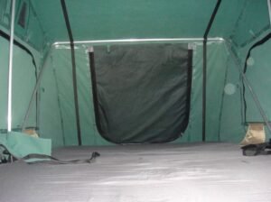 Close-up view of the rooftop tent canopy supported by a pole.