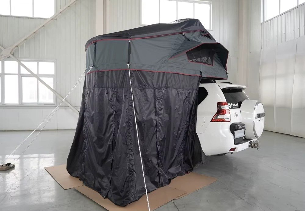Side view of a vehicle-mounted rear tent with an extended enclosed camping shelter