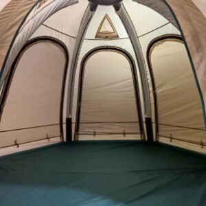 Interior of a beige camping tent showing arched inner doorways, mesh panels, and a green floor.