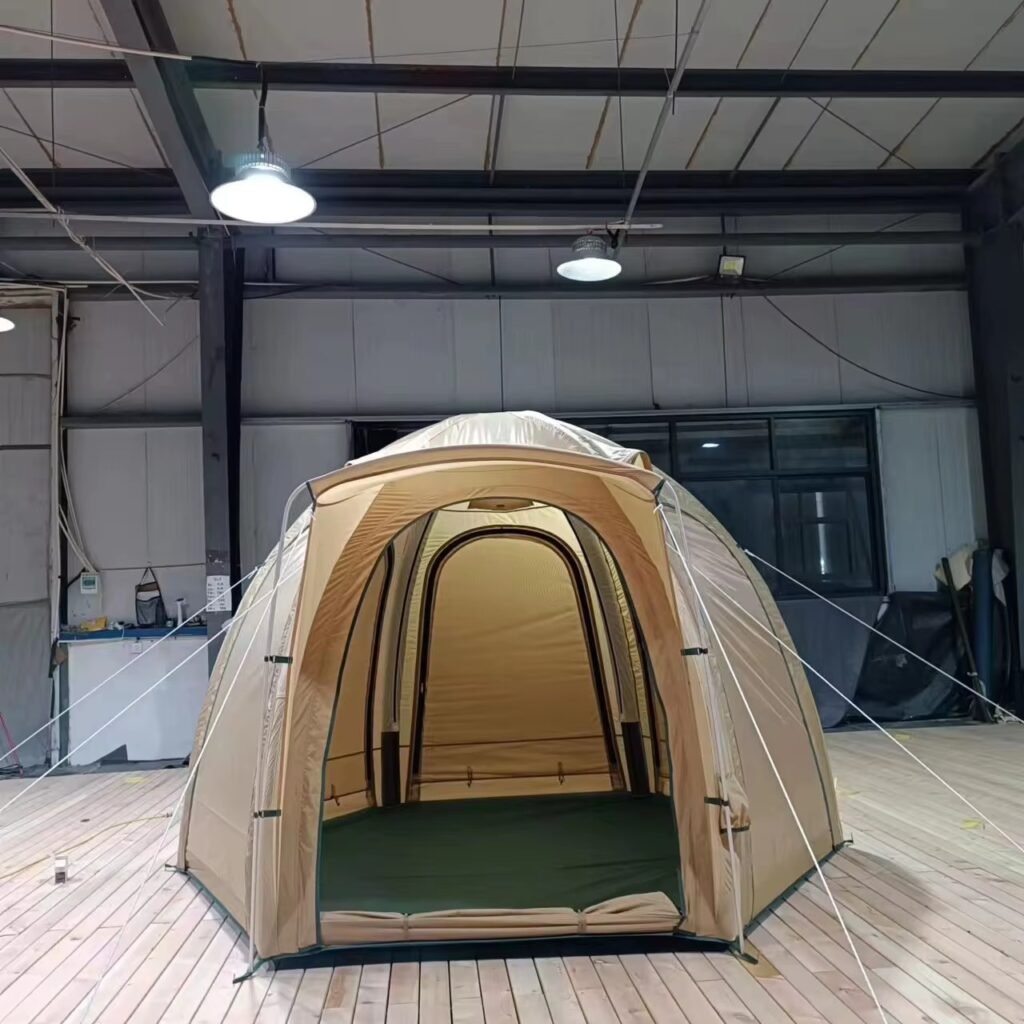 Beige inflatable camping tent displayed with the front entrance open on a wooden deck.