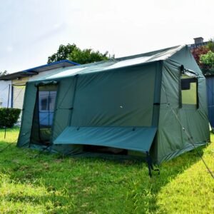 Green extended camping tent showing a large side panel, window, raised rain flap, and guy lines on grass.