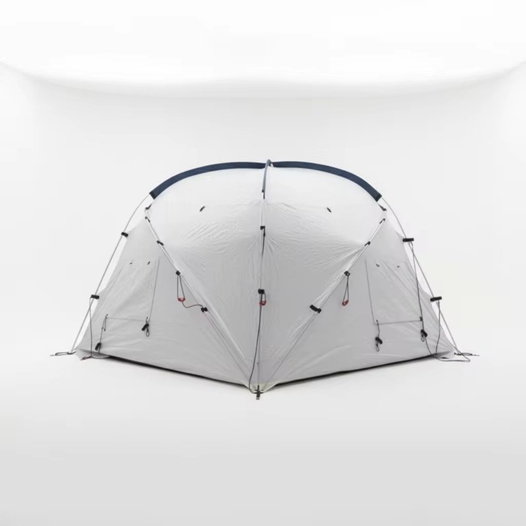 Rear three-quarter view of a gray dome tent with curved support poles, attachment points, and guy lines.