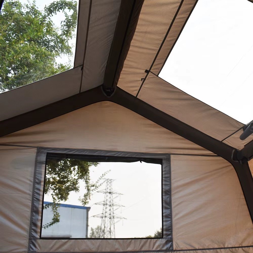 View from inside a camping tent showing the roof structure and a large mesh window.