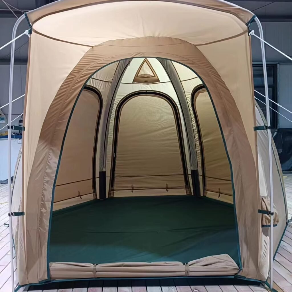 Close view of a beige tent's extended front canopy, arched entrance, and interior floor.