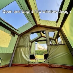 Interior view of a green camping tent with large clear roof windows, fabric panels, and an open doorway.