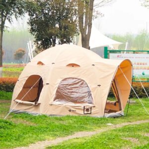 Side view of a beige family air dome tent with open entrances and window panels on a lawn