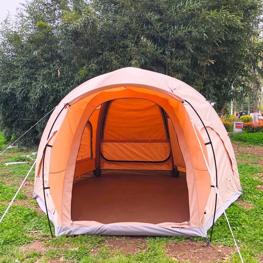 Front view of a beige dome camping tent with the entrance open and interior visible