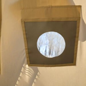 Interior close-up of a mesh window panel in a beige camping tent.