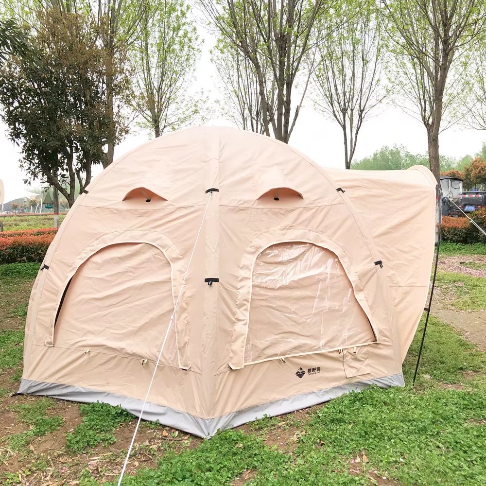 Rear-side view of beige family camping tent with two covered window panels