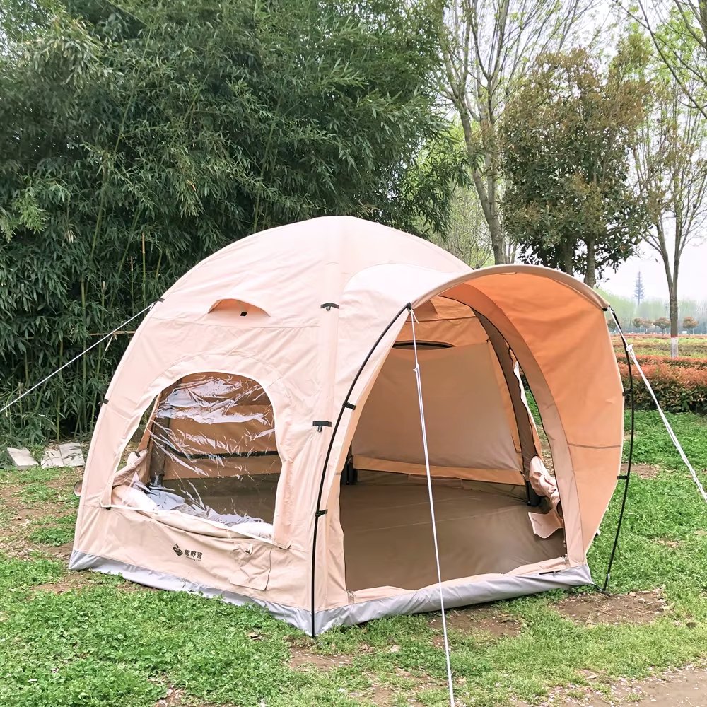 Front-side view of a beige air dome tent with open entrance and side window