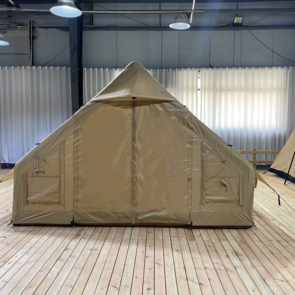 Front view of a beige inflatable tent with the mesh door open.
