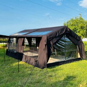 Dark outdoor tent with blue-tinted roof panels and a clear side panel
