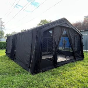 Dark tent with an open entrance and gridded mesh windows on a lawn
