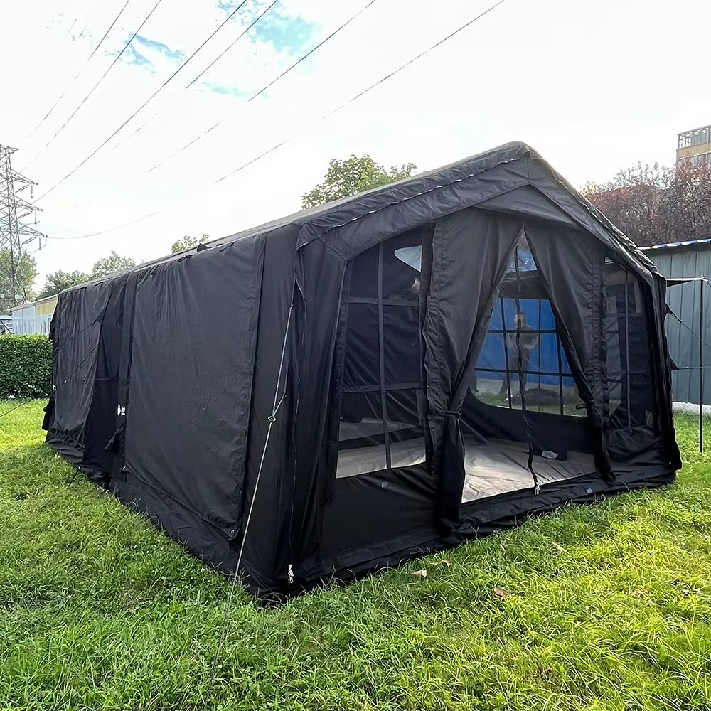 Dark tent with an open entrance and gridded mesh windows on a lawn