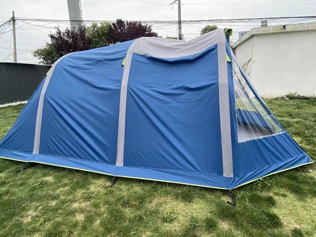Blue and gray inflatable camping tent with a clear window panel near one end.