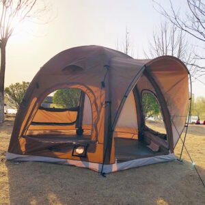 Brown tent with an open entrance and extended canopy in a park