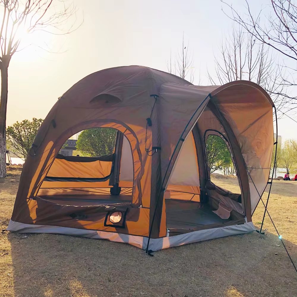 Brown tent with an open entrance and extended canopy in a park