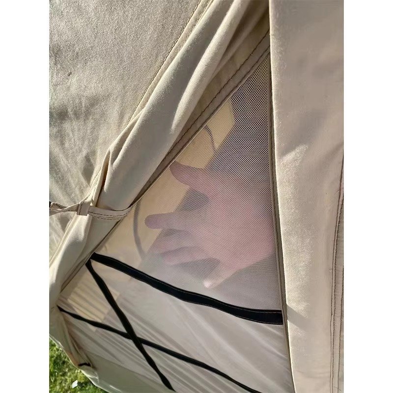 Close-up of a mesh window panel on a khaki cabin tent.