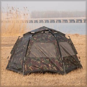 Camouflage hexagonal camping tent set up in a field.
