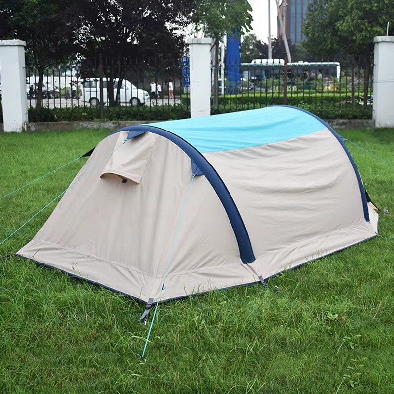 Rear view of a gray and blue inflatable camping tent with a closed rear panel.