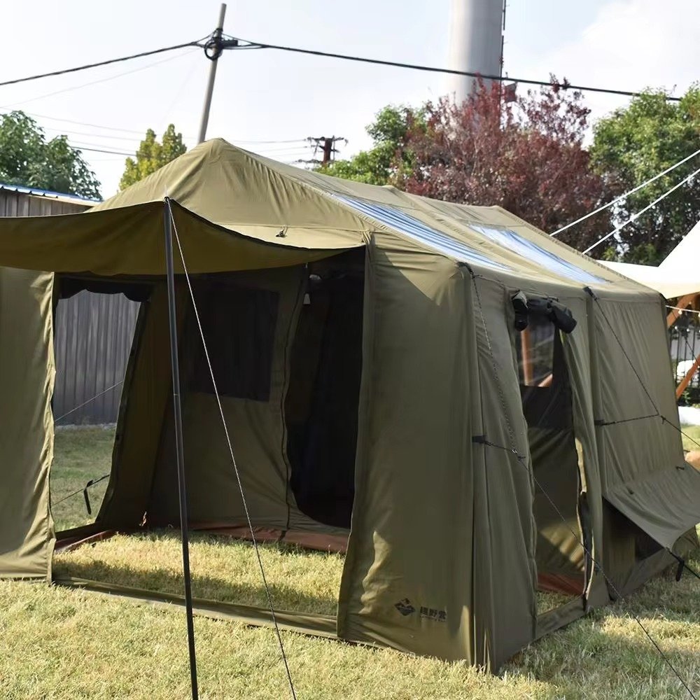 Olive green cabin camping tent with open front entrance, mesh panels, and extended awning on grass.