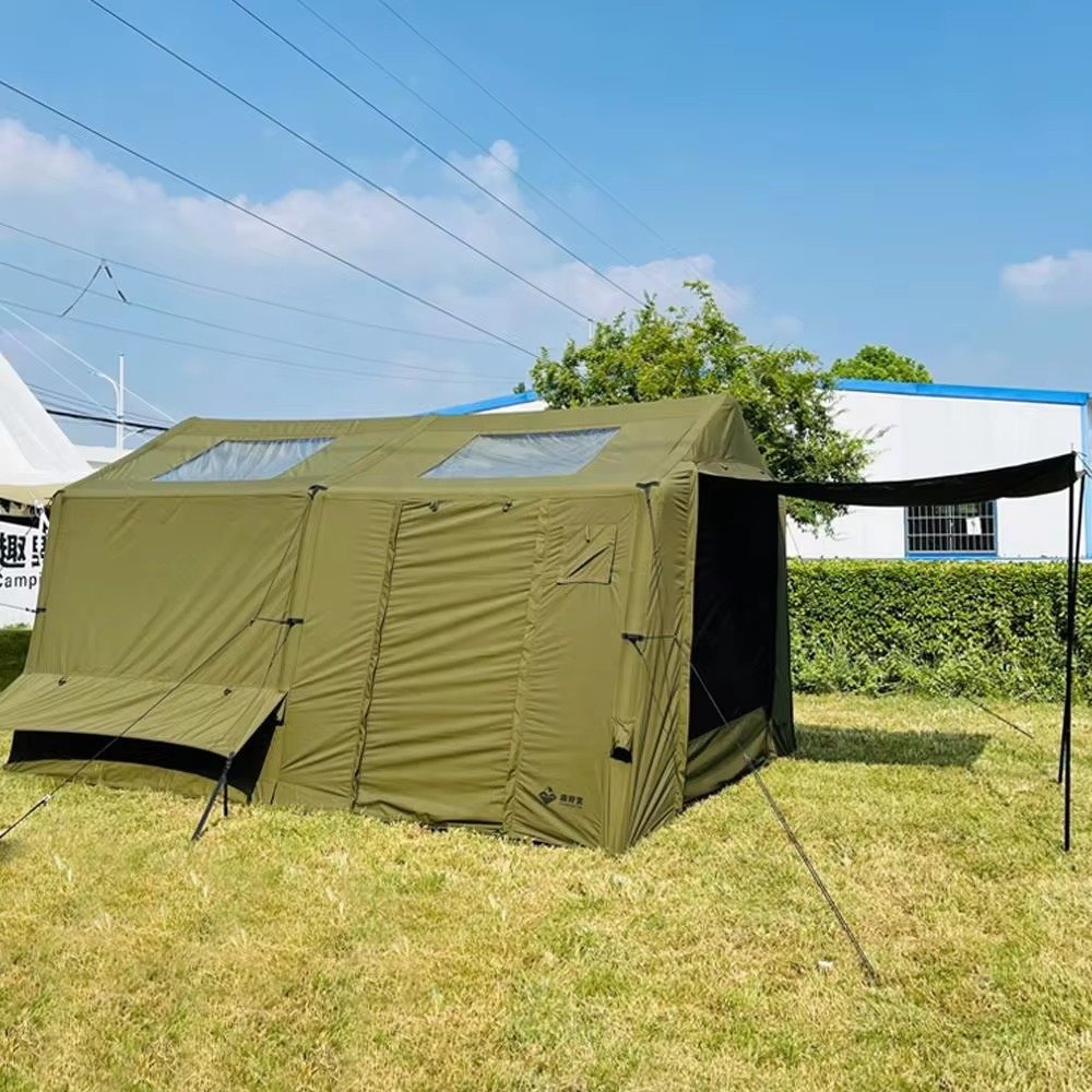 Olive green cabin tent with closed front entry panels, roof skylights, and a side awning.