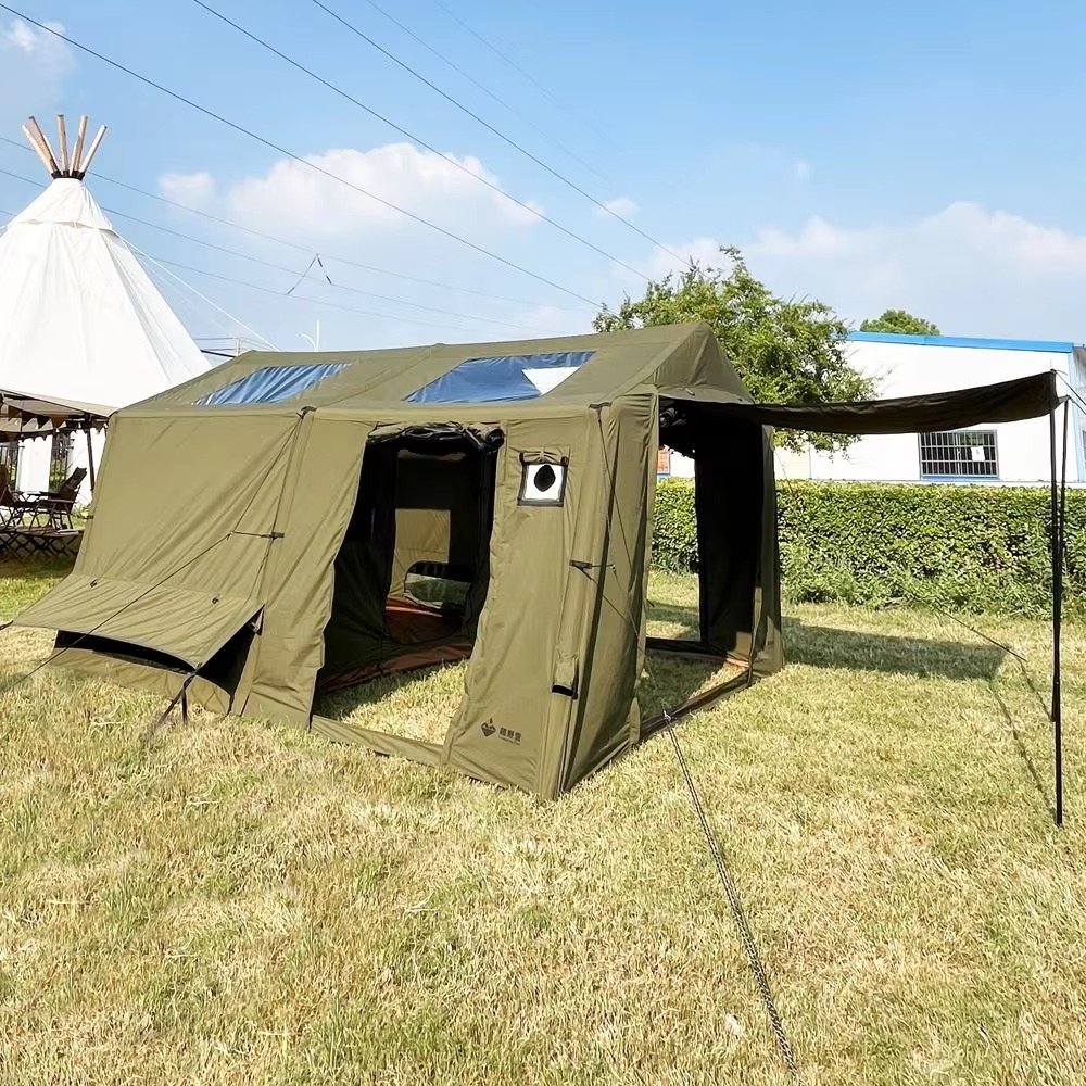 Olive green cabin tent with roof skylights, open entrance, and extended side awning at a campsite.