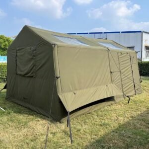 Rear-side view of an olive green cabin camping tent with closed fabric panels and guy lines.