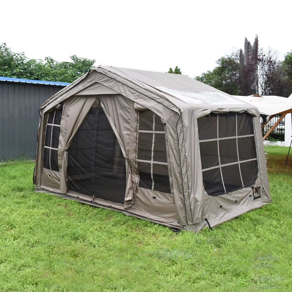 Gray-beige glamping tent set up on a grassy lawn